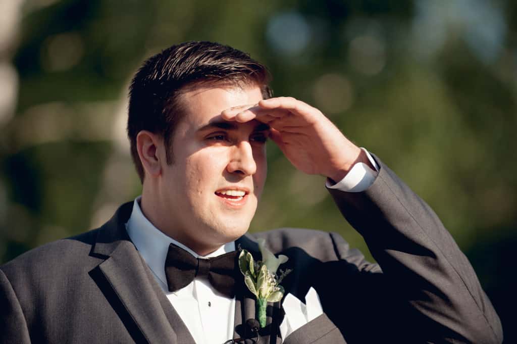 groom seeing bride for the first time at end of aisle 