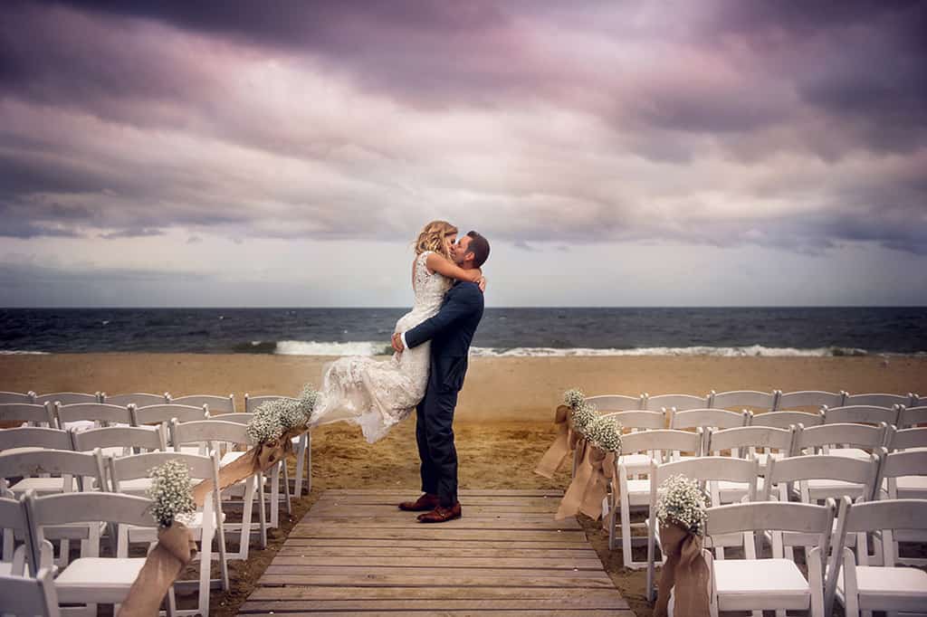 bride and groom kissing on the beach at NJ shore wedding