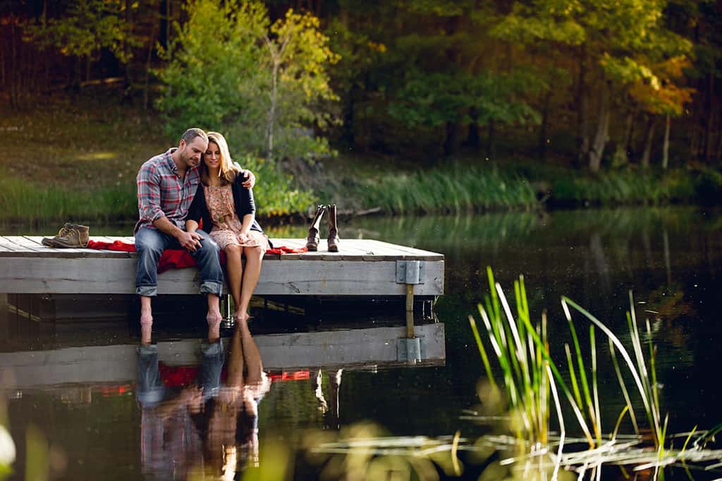 Couple on dock at lake engagement session