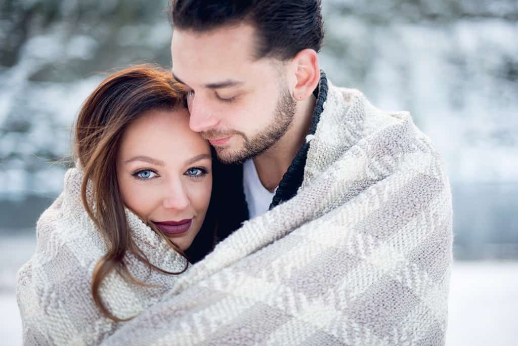 winter engagement session - couple wrapped in blanket