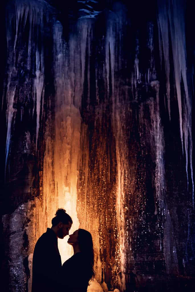 Winter Engagement Session - Couple under icicles
