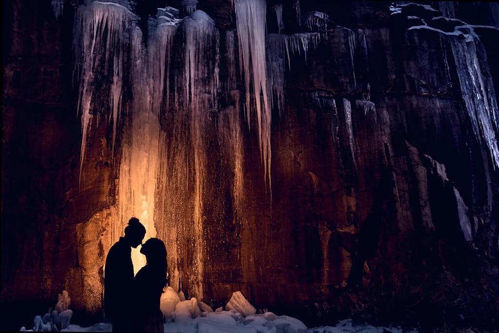 winter engagement session - couple under icicles