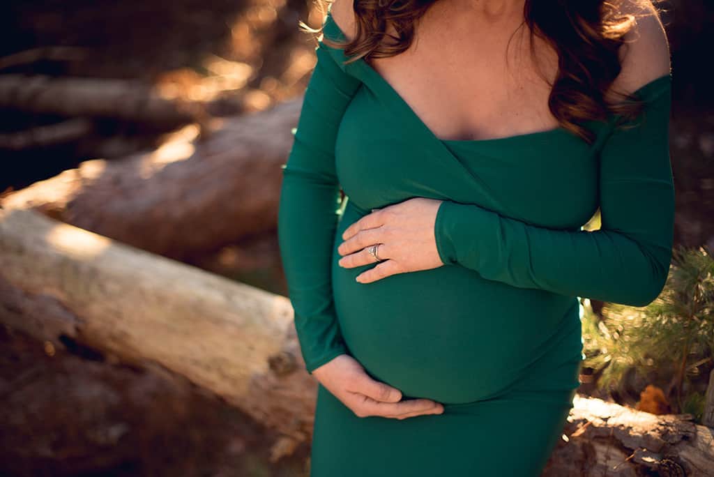 Ethereal Maternity Session in Forest with emerald green closeup of belly