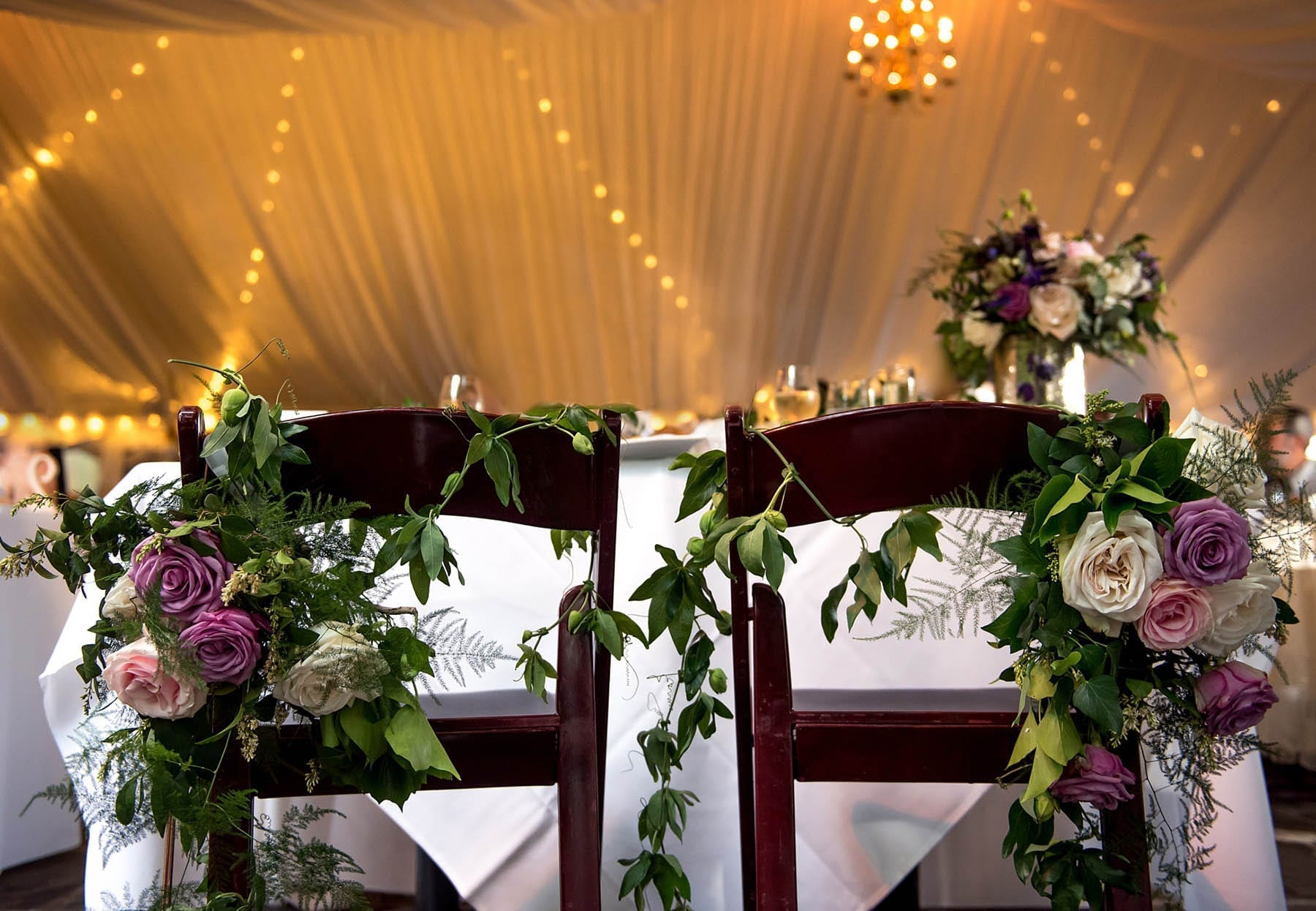 New Leaf Restaurant Summer Garden Wedding Details in tent with draped fabric and chandeliers 