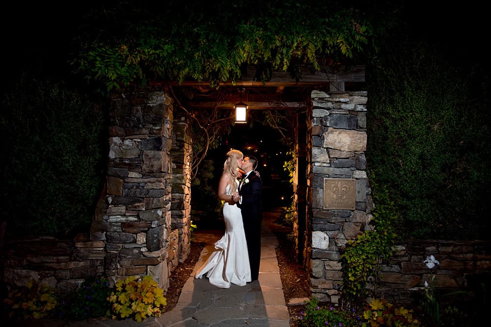 Romantic evening bride and groom portrait in stone archway at bedford post inn