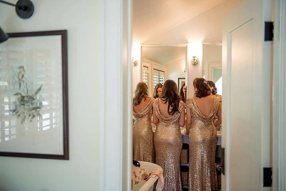 bridesmaids in sequin dip back dresses getting ready at Bedford Post Inn