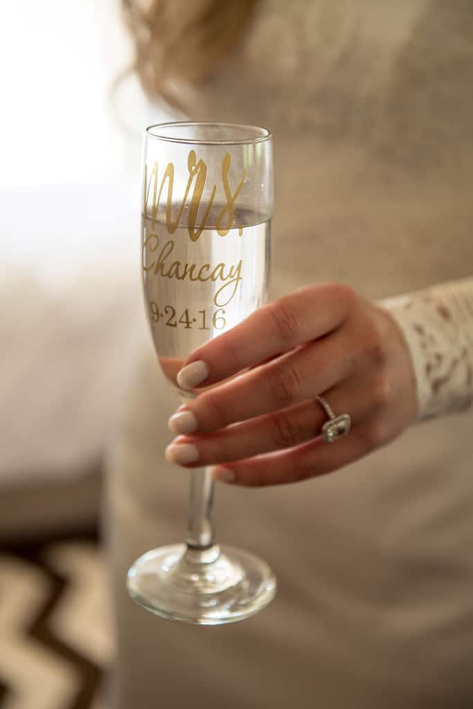 bride holding custom wedding champagne glass 