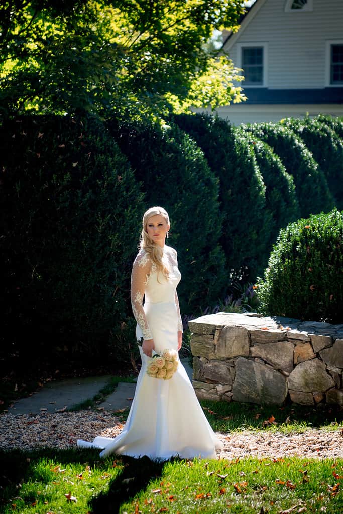 bride in Romona Keveza wedding dress with lace valero at bedford post inn