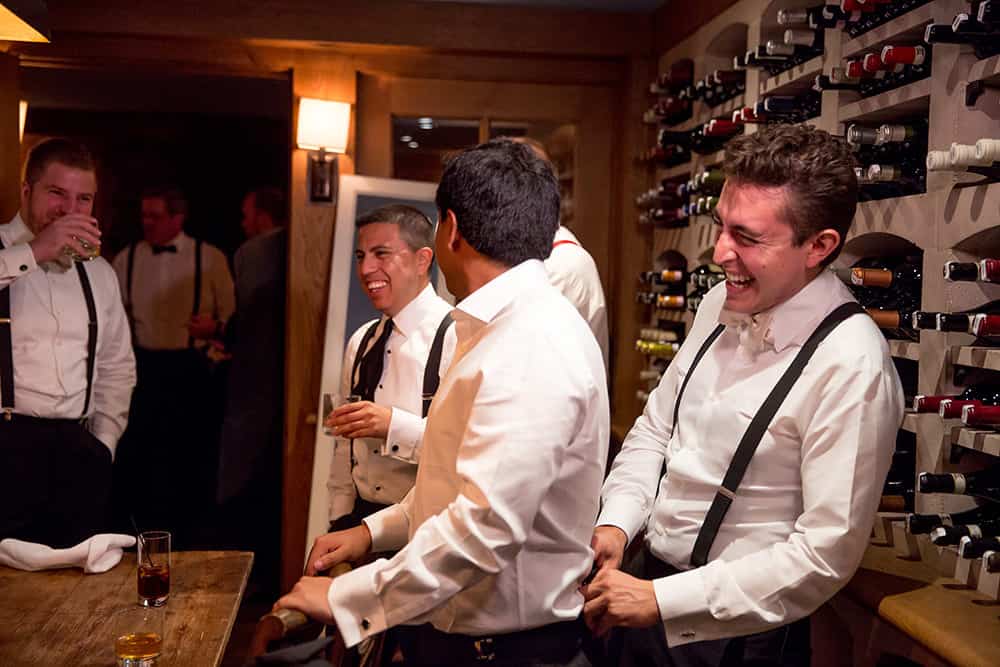 groom getting ready with groomsmen in wine cellar at bedford post inn