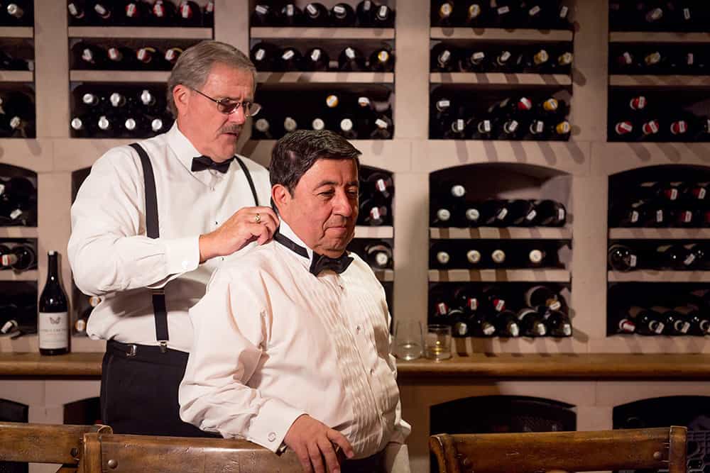 groom getting ready with groomsmen in wine cellar at bedford post inn