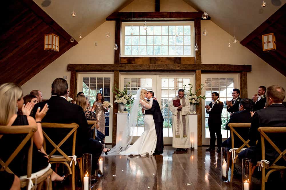 first kiss at romantic candlelit bedford post inn ceremony in yoga loft