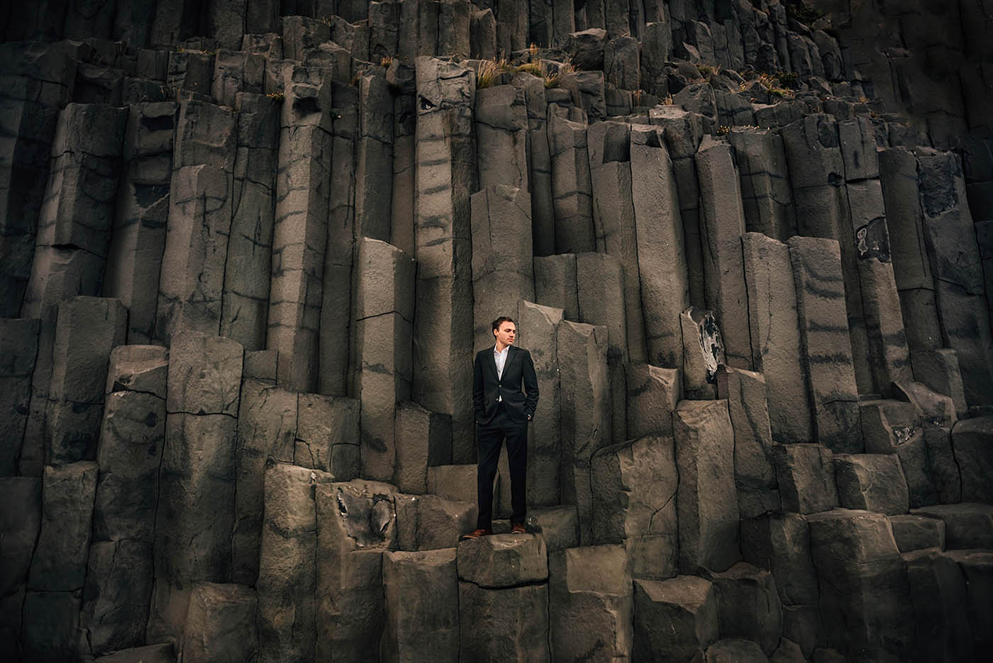Groom on Basalt Columns at Reynisfjara Black Sand Beach Iceland