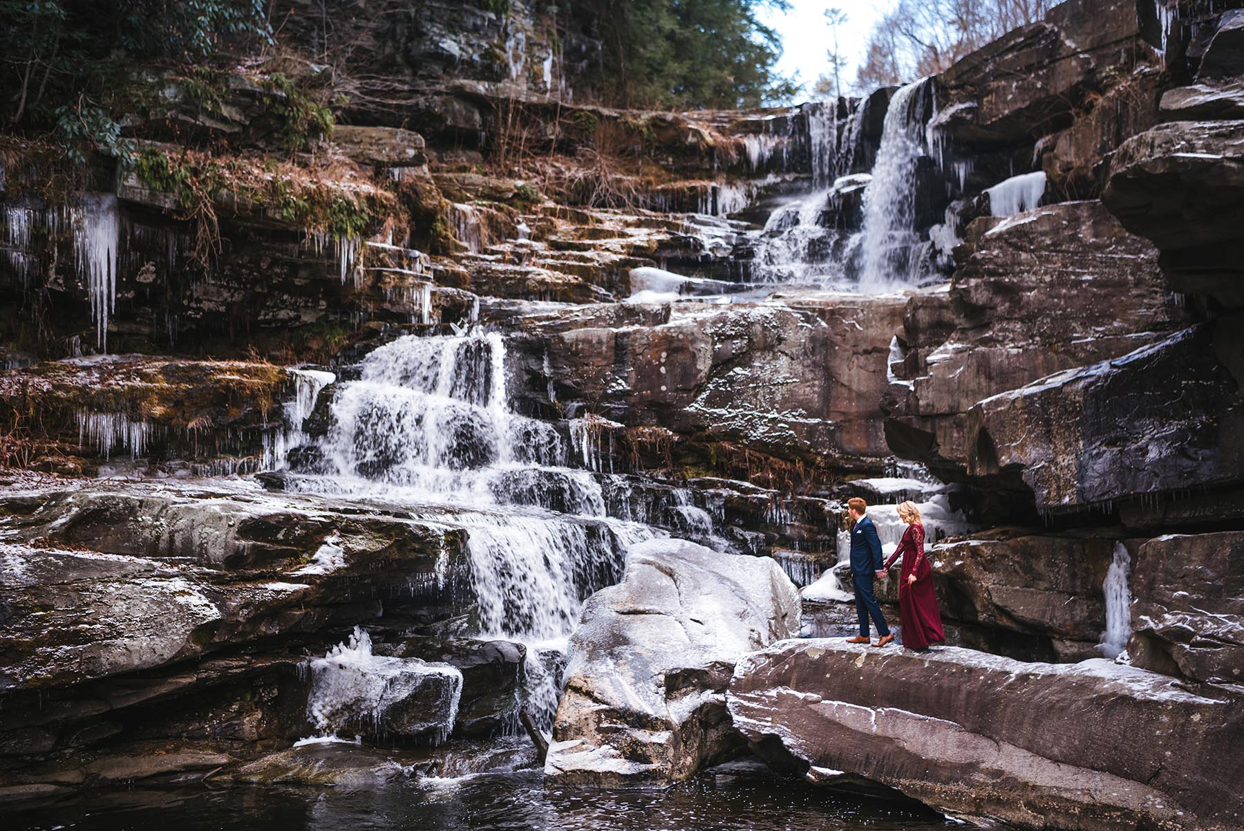 Poconos adventure engagement session at frozen waterfall